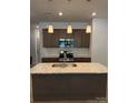 Modern kitchen featuring a central island with granite countertops and stainless steel appliances at 2910 Sloan Dr, Charlotte, NC 28208