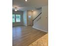 Open-concept living area with hardwood floors, staircase, and lots of natural light at 2910 Sloan Dr, Charlotte, NC 28208