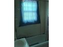 A bathroom featuring a shower-tub, and a window partially covered by a curtain at 2925 Titman Rd, Gastonia, NC 28054