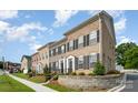 Brick townhome showcasing a front yard, black shutters, and well-maintained landscaping at 309 N Aspen St, Lincolnton, NC 28092