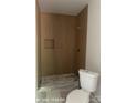 Bathroom showcasing a modern shower stall with sleek vertical tiling and a toilet at 312 Wesley Heights Way # B, Charlotte, NC 28208