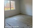 Bright bedroom featuring newly installed flooring and a large window offering natural light at 312 Wesley Heights Way # B, Charlotte, NC 28208