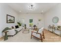 Bright and airy living room with hardwood floors, modern furniture, and large windows providing natural light at 3478 Winters St, Newton, NC 28658