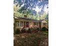 Charming single-story brick home with red shutters and a covered front porch at 3715 Vanderburg Dr, Concord, NC 28025
