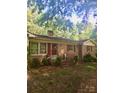 Charming single-story brick home with red shutters and a covered front porch at 3715 Vanderburg Dr, Concord, NC 28025