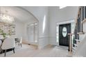 Bright foyer with a black front door, wainscotting, and hardwood floors at 3741 Tea Olive Rd, Gastonia, NC 28056