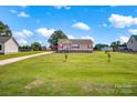 Inviting single-story home with a spacious front yard, long driveway, and additional outbuildings at 509 Brawley Rd # 7, Cleveland, NC 27013