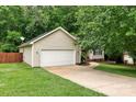 The tan exterior shows a one-story house with a two-car garage and landscaping at 605 Beavers Cove Nw Ln # 15, Concord, NC 28027