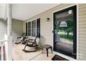 Welcoming front porch with rocking chairs and a 'Welcome' door mat next to the front door at 605 Beavers Cove Nw Ln # 15, Concord, NC 28027