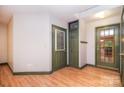Welcoming entryway with beautiful wood floors, multiple doors, and neutral paint offering a bright, airy feel at 6227 Dogwood Ln, Waxhaw, NC 28173
