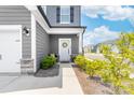 Inviting townhome entry with covered porch, detailed trim, stone accents, and neat landscaping at 711 Bellmouth Rd, Clover, SC 29710