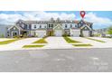 A row of townhomes showcasing diverse colors, each featuring a private driveway and a one-car garage at 711 Bellmouth Rd, Clover, SC 29710