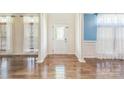 Bright foyer with hardwood floors, featuring decorative columns and natural light at 8336 Early Bird Way, Mint Hill, NC 28227