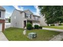 Attractive two-story home with gray siding, stone accents, and a well-maintained front yard at 8511 Redding Glen Ave, Charlotte, NC 28216