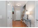 Welcoming entryway with hardwood floors, a table lamp, and staircase at 916 Coffee Tree Ln, Rock Hill, SC 29732