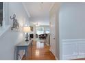 Inviting hallway with hardwood floors leading to a living room with a fireplace at 916 Coffee Tree Ln, Rock Hill, SC 29732