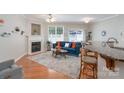 Cozy living room featuring a fireplace, ceiling fan, and access to the patio at 916 Coffee Tree Ln, Rock Hill, SC 29732