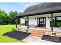 Inviting front porch with a swing and stylish black accents, perfect for relaxing outdoors at 930 Hawley Rd, McConnells, SC 29726