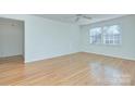 Bright, empty room with hardwood floors, neutral walls, and a window at 101 S Laurel Ave # 72A, Charlotte, NC 28207