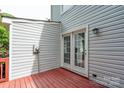 Image of the wooden deck with white siding and white trim French doors at 1013 Doby Springs Dr, Charlotte, NC 28262