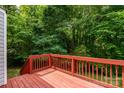 Picture of a wooden deck with a stained red finish and a view of the backyard at 1013 Doby Springs Dr, Charlotte, NC 28262
