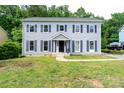 Traditional two-story home featuring light gray siding and striking blue shutters at 1013 Doby Springs Dr, Charlotte, NC 28262