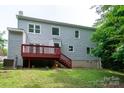 View of the rear elevation with wood deck, siding, and established lawn at 1013 Doby Springs Dr, Charlotte, NC 28262