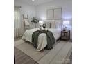 Cozy bedroom featuring soft lighting, decorative artwork, and a comfortable bed at 1015 4Th St, Spencer, NC 28159