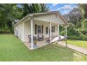 Charming home featuring a cozy front porch with seating and decorative plants at 1016 W 10Th Ave, Gastonia, NC 28052