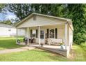 Inviting front porch with a white bench and cozy seating, perfect for relaxing outdoors at 1016 W 10Th Ave, Gastonia, NC 28052