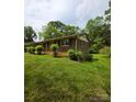 Side angle of a brick home showcasing the home's architecture and well-maintained lawn at 1105 Stanton Dr, Shelby, NC 28150