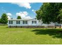 Inviting single-story home with a cozy front porch and lush green lawn at 1107 Richard Rd, Salisbury, NC 28147