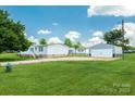 Spacious property with a well-maintained house and detached garage, surrounded by a large green lawn at 1107 Richard Rd, Salisbury, NC 28147
