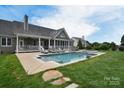 Inviting in-ground pool with lounge area and spa at 11772 Sugar Hill Rd, Davidson, NC 28036