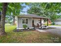 Charming home featuring a welcoming front porch, fresh landscaping, and a mix of modern and traditional design elements at 118 Globe St, Mount Holly, NC 28120