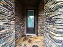 Inviting front door framed by stone, accented by stone flooring and offering a glimpse of the landscaped front yard at 1190 Arges River Dr, Fort Mill, SC 29715
