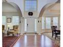 Grand foyer with soaring ceilings, hardwood floors, and elegant architectural details at 12125 Mountainside Ln, Charlotte, NC 28278