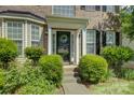Inviting front entrance with decorative wreath, covered porch, and manicured bushes at 12125 Mountainside Ln, Charlotte, NC 28278