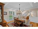 Dining room with a chandelier, large windows, and wood floors at 166 Pinnacle Shores Dr, Mooresville, NC 28117