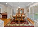 Traditional dining room featuring wood table, chandelier, and large windows for natural light at 166 Pinnacle Shores Dr, Mooresville, NC 28117