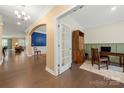 Elegant foyer showcasing hardwood floors, and arched doorway leading to a dining area at 17028 River Race Dr, Huntersville, NC 28078