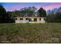 Exterior shot of updated single-story home during dusk, showcasing its curb appeal at 174 Maske Rd, Mount Gilead, NC 27306