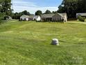 Expansive lawn frames this home with mature trees; great curb appeal and neighborhood feel at 190 Watering Trough Rd, Statesville, NC 28677