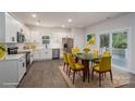 Bright kitchen with stainless steel appliances, white cabinets, and a dining area with sliding door access to the backyard at 1941 32Nd Ne St, Hickory, NC 28601