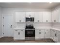 Modern kitchen with stainless steel appliances, white cabinets, and quartz countertops at 1941 32Nd Ne St, Hickory, NC 28601