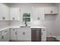 Bright kitchen featuring white cabinets, stainless steel appliances, and a window over the sink at 1941 32Nd Ne St, Hickory, NC 28601