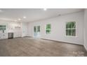 Open-concept living area with wood-look flooring, natural light and access to a deck at 1941 32Nd Ne St, Hickory, NC 28601