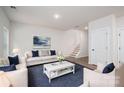 Comfortable living room with hardwood floors, a plush sofa, stylish decor, and a staircase leading to the upper level at 1941 32Nd Ne St, Hickory, NC 28601