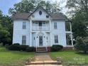 Two-story home with columns, front yard with greenery, sidewalk leading to the house at 204 N Gaston St, Kings Mountain, NC 28086
