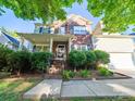 Beautiful two-story home with brick accents, a covered front porch, and lush landscaping at 2111 Elendil Ln, Charlotte, NC 28269